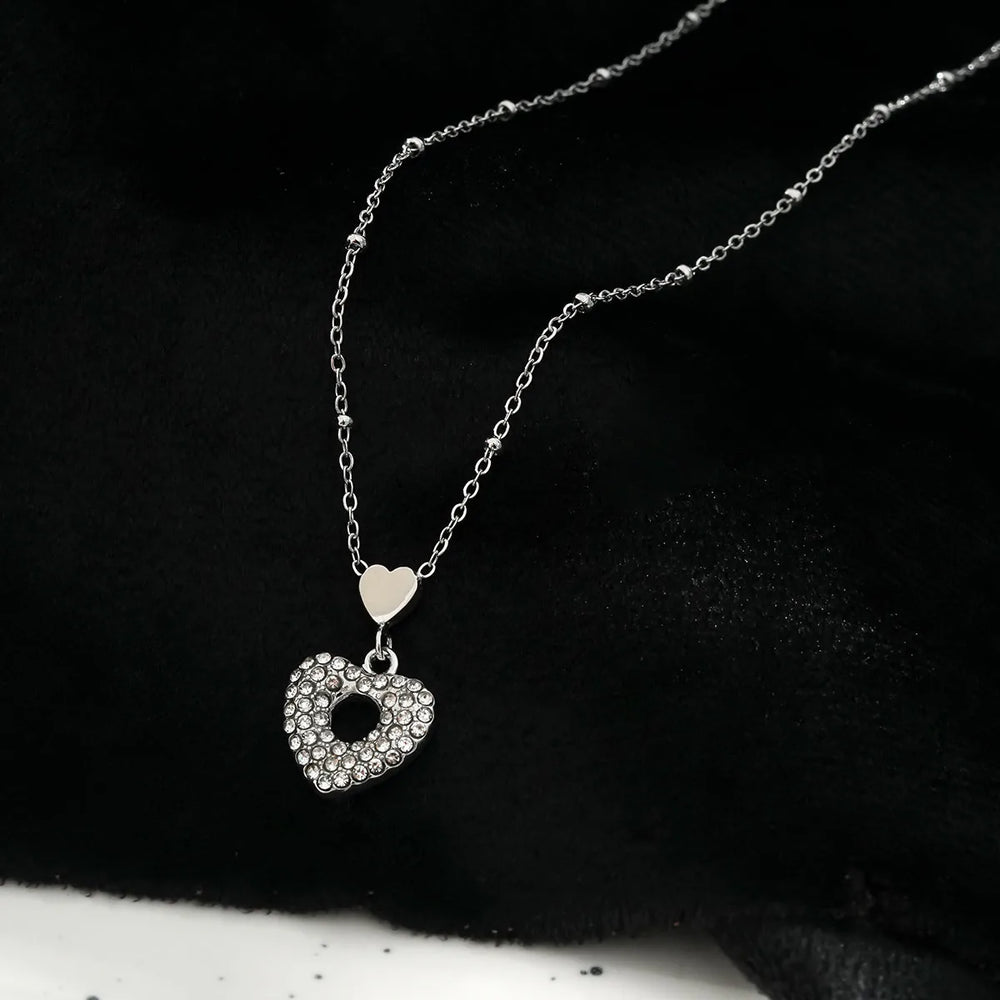 ETERNAL : Collier avec pendentif double cœur incrusté de zircone pavée